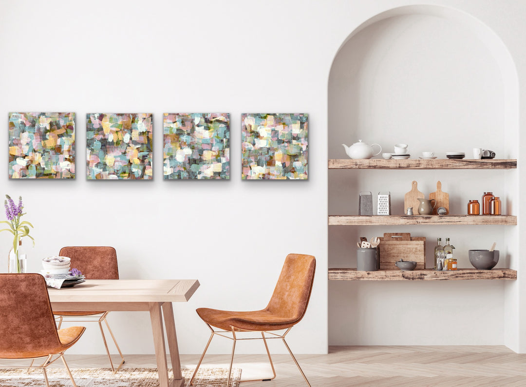 Four original hand-painted abstract coordinating artworks displayed in a row on a dining room wall.  The four paintings are the same colors and style but all slightly different in design.