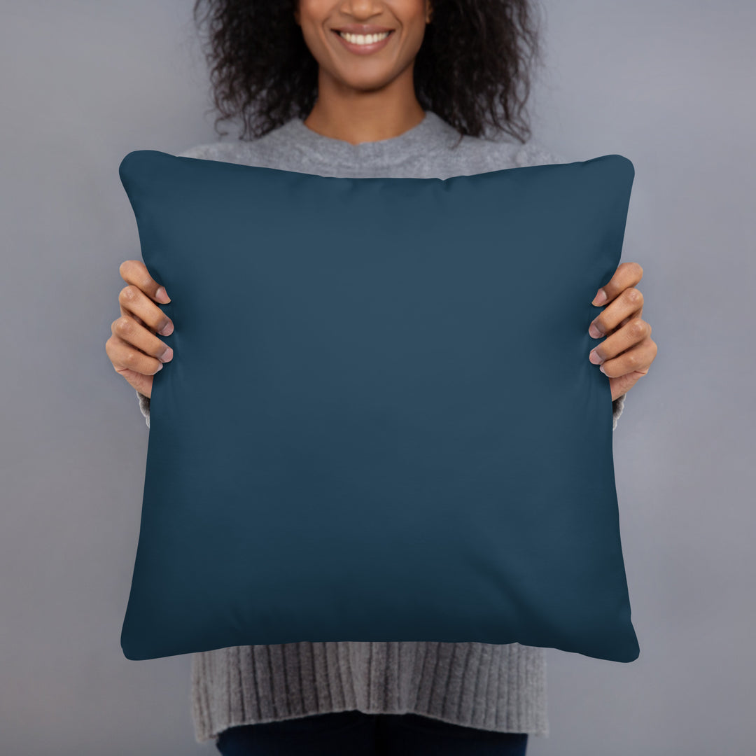 Woman holding folk art pillow in her hands showing back side.